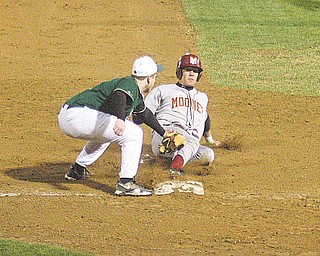Ursuline infi elder Harrison Finelli puts the tag on Cardinal Mooney’s Boo Vazquez during their game Monday night in Struthers.