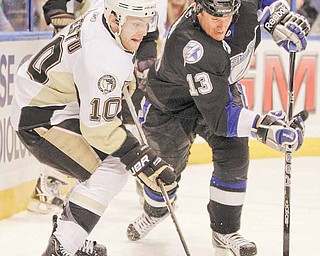 Pittsburgh Penguins center Mark Letestu (10) battles with Tampa Bay Lightning defenseman Pavel Kubina, of the Czech Republic, (13), for the puck during the first period in Game 3 of a first-round NHL Stanley Cup playoff series Monday, April 18, 2011 in Tampa, Fla. 