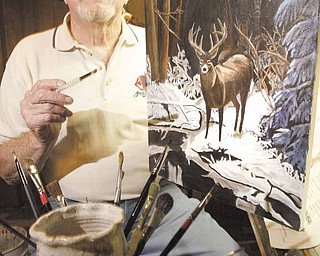 Robert J. Rider Sr. of Austintown, self-taught artist and Korean War-era veteran, sits in his basement-corner studio with one of his paintings showing his favorite subject — the outdoors. 