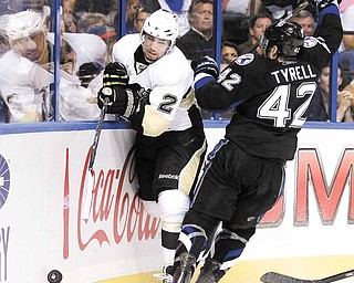 Tampa Bay Lightning center Dana Tyrell (42) slams Pittsburgh Penguins defenseman Matt Niskanen (2) into the boards during the second period in Game 3 of a first-round NHL Stanley Cup playoff series Monday, April 18, 2011 in Tampa, Fla.