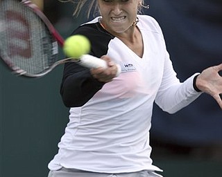 Sabine Lisicki, of Germany, returns a shot against Sania Mirza, of India, during the Family Circle Cup tennis tournament in Charleston, S.C., Thursday, April 7, 2011. Mirza defeated Lisicki 6-4, 6-4. 