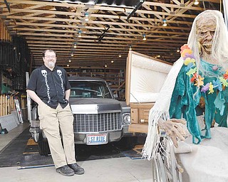 Rick Davis, founding member of Darkride and Funhouse Enthusiasts, stands in his garage workshop in Vienna.
