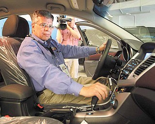 Mark Santilli, marketing manager for Jeff Gordon Chevrolet in Wilmington, N.C., picks up one of the 100 Cruzes his dealership recently took on from the Lordstown General Motors complex.