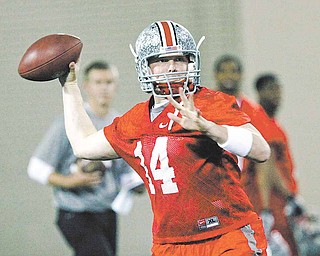 In this March 31, 2011 file photo, Ohio State quarterback Joe Bauserman (14) throws a pass during the first day of NCAA college football practice in Columbus, Ohio.