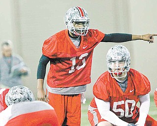 In this photo made March 31, 2011, Ohio State quarterback Kenny Guiton (13) calls out a play during the first day of NCAA college football practice in Columbus, Ohio. 