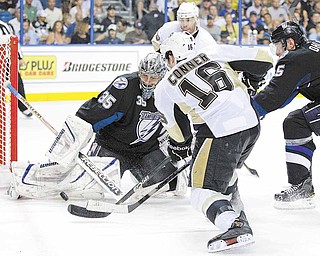 Tampa Bay Lightning goalie Dwayne Roloson (35) stops a shot by Pittsburgh Penguins right wing Chris Conner (16) during the third period in Game 4 of a first-round NHL Stanley Cup playoff series on Wednesday, April 20, 2011, in Tampa, Fla.