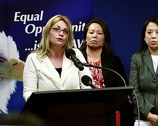 Kay Buck, left, executive director of the Coalition to Abolish Slavery Trafficking, speaks at a news conference Wednesday, April 20, 2011, to announce the filing of a human trafficking lawsuit that stretches across California , Hawaii, and Washington. Anna Park, regional attorney for the EEOC in the Los Angeles District, center, and Chanchanit Martorell, executive director for the Thai Community Development Center, listens in.