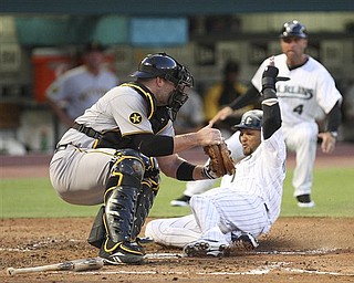 Florida Marlins' Emilio Bonifacio, right, slides in safe at home as the Pittsburgh Pirates catcher Chris Snyder is unable to tag him out after during the second inning of a baseball game at Sun Life Stadium in Miami, Wednesday, April 20, 2011.
