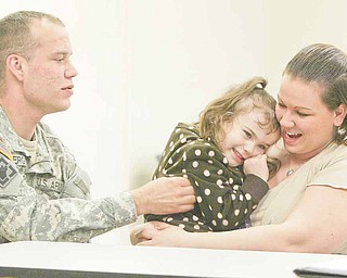 Four-year-old Mackenize Snyder of Sharon, Pa., giggles as her uncle, Army Reserve Spec. Douglas Ferguson, tickles her. She is in the arms of her mother, Amanda Snyder, Ferguson’s sister. Mackenize was 2 when her uncle deployed to Afghanistan.