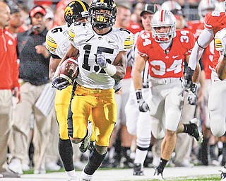 Iowa's Derrell Johnson-Koulianos (15) return a kickoff 99-yards for a touchdown during the fourth quarter of an NCAA college football game against Ohio State, Saturday, Nov. 14, 2009, in Columbus, Ohio. 