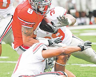 Ohio State wide receiver DeVier Posey (8) runs the ball as Jeremy Cash, front, and David Conor (39) make the tackle during an NCAA college football Spring Game, Saturday, April 23, 2011, in Columbus, Ohio.