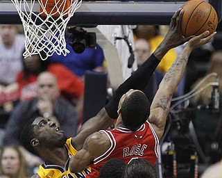 Indiana Pacers' Roy Hibbert, left, blocks the shot of Chicago Bulls' Derrick Rose  during the second half of Game 4 of a first-round NBA basketball series in Indianapolis, Saturday, April 23, 2011. Indiana won 89-84.