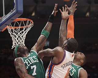 Boston Celtics center Jermaine O'Neal (7) and forward Glen Davis, right, go up for a rebound with New York Knicks forward Amare Stoudemire (1) in the first half of Game 4 of a first-round NBA basketball playoff series at Madison Square Garden in New York, Sunday, April 24, 2011. 