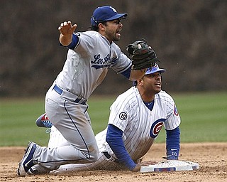 Los Angeles Dodgers second baseman Aaron Miles and Chicago Cubs' Aramis Ramirez look for the call after Ramirez overran second base and was thrown out by Dodgers left fielder Jerry Sands in the sixth inning of the Dodgers' 7-3 win in a baseball game Sunday, April 24, 2011 in Chicago.