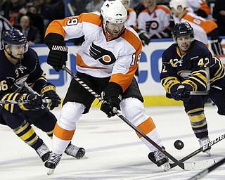 Philadelphia Flyers' Scott Hartnell (19) battles for the puck with Buffalo Sabres' Nathan Gerbe (42) and Patrick Kaleta (36) during the second period in Game 6 of a first-round NHL Stanley Cup playoffs hockey series, in Buffalo, N.Y., Sunday, April 24, 2011. 