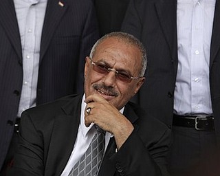 Yemeni President Ali Abdullah Saleh smiles while looking at  his supporters, not pictured, during a rally in his support, in Sanaa,Yemen, Friday, April 22, 2011. Opponents and supporters of Yemen's embattled president are marching in cities and towns across the nation for rival rallies after Friday prayers.
