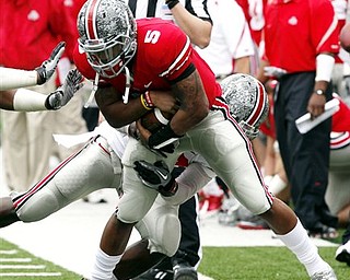 Ohio State quarterback Braxton Miller (5) is tackled by Nate Oliver during an NCAA college football Spring Game, Saturday, April 23, 2011, in Columbus, Ohio.