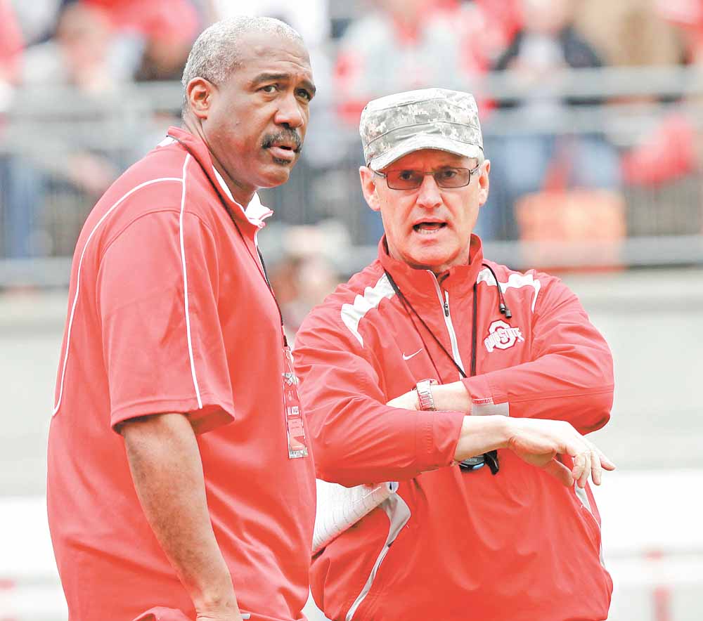 This April 23, 2011, file photo shows Ohio State director of athletics Gene Smith, left, talking to head football coach Jim Tressel, right, before an NCAA college football Spring Game, in Columbus, Ohio. The NCAA is accusing Tressel of lying to hide violations by players who traded memorabilia for cash and tattoos.  In a "notice of allegations" sent to the school, the NCAA said Monday, April 25, 2011,  that the alleged violations relating to the coach are considered "potential major violations."
