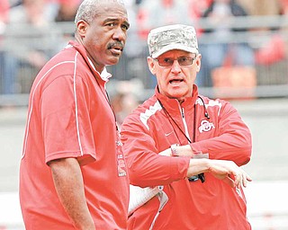 This April 23, 2011, file photo shows Ohio State director of athletics Gene Smith, left, talking to head football coach Jim Tressel, right, before an NCAA college football Spring Game, in Columbus, Ohio. The NCAA is accusing Tressel of lying to hide violations by players who traded memorabilia for cash and tattoos.  In a "notice of allegations" sent to the school, the NCAA said Monday, April 25, 2011,  that the alleged violations relating to the coach are considered "potential major violations."