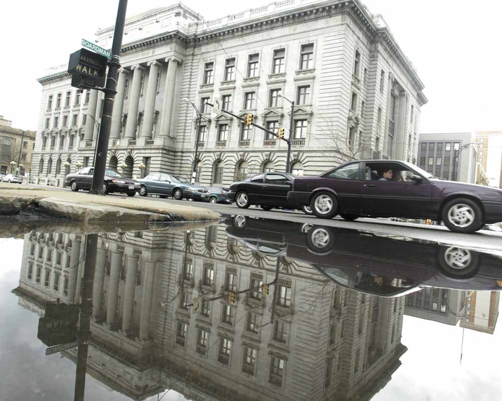 The county courthouse in downtown Youngstown is reflected in standing water Monday after more than a week of rain. 