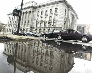 The county courthouse in downtown Youngstown is reflected in standing water Monday after more than a week of rain. 