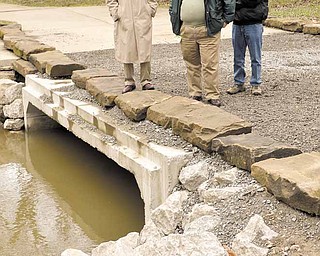 Members of the Poland Forest Foundation, Bob Lenga, left and Gordon Longmuir, right, and Forest Board Chairman Bob Zedaker, center, examine improvements made to the Poland Municipal Forest’s Bluebell Trail Wednesday afternoon.