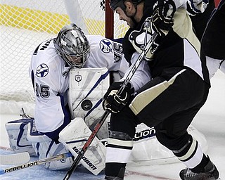 Pittsburgh Penguins' Craig Adams, right, can't get a shot past Tampa Bay Lightning goalie Dwayne Roloson (35) in the third period of Game 5 of a first-round NHL Stanley Cup playoff series in Pittsburgh Saturday, April 23, 2011. The Lightning won 8-2.