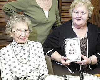 Pat Gergel stands with Olga Brown, left, president of St. Anne’s Guild, and Carol Kaszowski, guild vice president. They have been involved with the publication of the 100th Anniversary Edition of “Book of Golden Recipes,” marking the anniversary of Holy Trinity Ukrainian Catholic Church of Youngstown.
