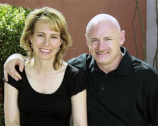 This undated file photo provided by the office of Rep. Gabrielle Giffords, shows Giffords, left, with her husband, NASA astronaut Mark Kelly. Giffords will attend her husband's space shuttle launch in Florida on Friday, Kelly said, allowing the Arizona congresswoman to travel for the first time since she was flown from Tucson to Houston more than three months ago to recover from a gunshot wound to the head. 