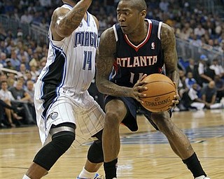 Atlanta Hawks' Jamal Crawford, right, looks to pass the ball past Orlando Magic's Jameer Nelson (14) during the first half of Game 5 of a first-round NBA playoff basketball series in Orlando, Fla., Tuesday, April 26, 2011.