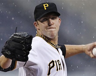 Pittsburgh Pirates pitcher Paul Maholm throws in the first inning of a baseball game against the Washington Nationals in Pittsburgh on Monday, April 25, 2011. 