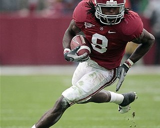 FILE - In this Nov. 26, 2010 file photo, Alabama receiver Julio Jones (8) runs for a first down in the first half of an NCAA college football game against Auburn at Bryant-Denny Stadium in Tuscaloosa, Ala. Jones is a top prospect in the upcoming NFL Draft.
