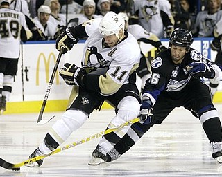 Tampa Bay Lightning right wing Martin St. Louis (26) knocks the puck away from Pittsburgh Penguins center Jordan Staal (11) during the third period in Game 6 of a first-round NHL Stanley Cup playoff series Monday, April 25, 2011 in Tampa, Fla.