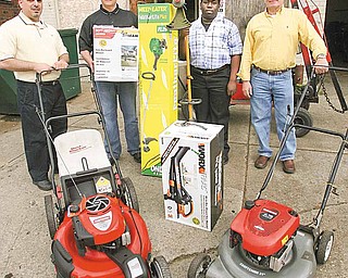 From left, the Rev. Al Yanno of Metro Assembly of God; Jim Lipjanic, co-owner of City Wide Lawn Equipment on Southern Boulevard; Travis Ranshaw, the church’s junior high pastor; and Mike Vargo, City Wide co-owner, show the donation of lawn mowers, leaf blowers and weed whackers to the church.
