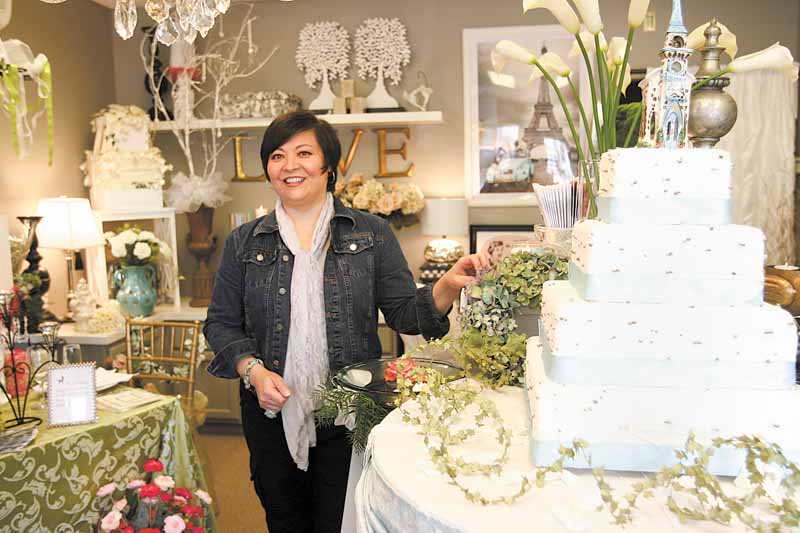 Linda Fowler of Poland shows off merchandise in her newly opened South Main Street wedding-planning business, Black Dog: Wedding and Special Event Design. The shop is designed to help brides bring to life the vision they have of their big day. 