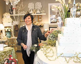 Linda Fowler of Poland shows off merchandise in her newly opened South Main Street wedding-planning business, Black Dog: Wedding and Special Event Design. The shop is designed to help brides bring to life the vision they have of their big day. 