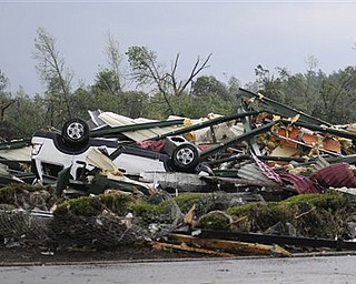 The remains of Hill's Carpet Center in Concord Ala., are seen after what appeared to be a tornado ripped through parts of the town late Wednesday, April 27, 2011. The damage in the area is extensive with homes and businesses destroyed and people injured.  (AP Photo/Birmingham News, Jeff Roberts)