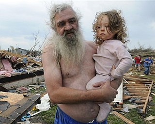 Willie Hyde holds his grand daughter 2-years-old Sierra Goldsmith near where their house stood in Concord Ala., after what appeared to be a tornado ripped through parts of the town late Wednesday, April 27, 2011. The damage in the area is extensive with homes and businesses destroyed and people injured.  (AP Photo/Birmingham News, Jeff Roberts)