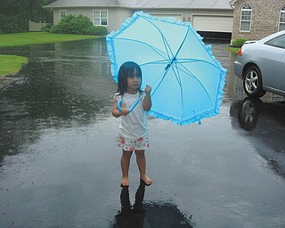 Norma Remias of Canfield sent this picture of her granddaughter, Jenni-Lin Remias of Poland, who was having a great time playing in the rain at Grandma's house.