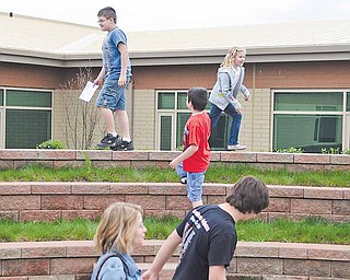 Families explore the courtyard in the center of the new school. The courtyard will be an outdoor classroom.