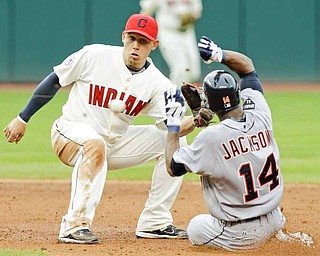 Cleveland Indians shortstop Asdrubal Cabrera takes the throw in time to tag out Detroit Tigers' Austin Jackson (14) trying to steal second base in the third inning of a baseball game Saturday, April 30, 2011, in Cleveland.