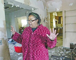 Joyce Jones of Youngstown, mother of filmmaker Derrick “D” Jones, walks through the home at 631 Ridge Ave., where she and her children once lived. Her son filmed a nine-minute documentary about the home, “631,” that Derrick has shown in Youngstown several times in the past few years.