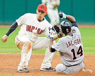 Cleveland Indians shortstop Asdrubal Cabrera takes the throw in time to tag out Detroit Tigers' Austin Jackson (14) trying to steal second base in the third inning of a baseball game Saturday, April 30, 2011, in Cleveland.
