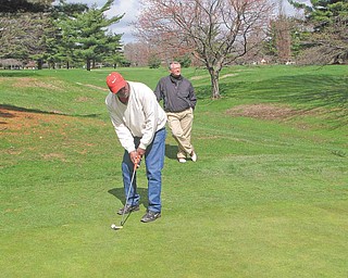 James Overton of Youngstown, under the watchful eye of PGA pro Dave Boos, prepares to take a shot on the No. 1 Par 4 Hole at the Henry Stambaugh Municipal Golf Course, where the 2011 Greatest Golf Holes of the Valley will tee off today. The event, sponsored by The Vindicator and Farmers National Bank in partnership with eight area golf courses, again showcases the best holes on area courses, but this time as determined by Valley golfers.