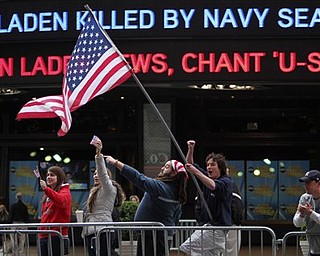 Melissa LaCour, left, Brittany McGarry, second from left, Bryan Murray, second from right, and Dennis Vincent celebrate outside the ABC studio in New York's Times Square as news of Osama bin Laden's death is announced on the ticker, Monday, May 2, 2011.