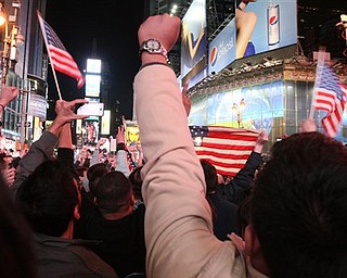 People in New York's Times Square react to the news of Osama Bin Laden's death early Monday morning May 2, 2011. President Barack Obama announced Sunday night, May 1, 2011, that Osama bin Laden was killed in an operation led by the United States.