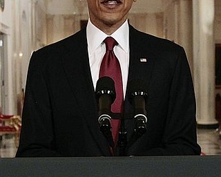 President Barack Obama reads his statement to photographers after making a televised statement on the death of Osama bin Laden from the East Room of the White House in Washington, Sunday, May 1, 2011.
