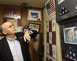 Mike Low, father of 911 World Trade Center victim American Airlines flight attendant Sara Low, describes flags sent to his family that have been flown in honor of his daughter over Afghanistan by members of the U.S. military at a wall displaying memorabilia of his daughter in his Batesville, Ark., office Monday, May 2, 2011. Osama Bin Laden, the face of global terrorism and mastermind of the Sept. 11, 2001, attacks, was tracked down and shot to death Monday in Pakistan by an elite team of U.S. forces, ending an unrelenting manhunt that spanned a frustrating decade.