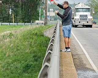 Gary Ruebush of Harrisonburg, Va., waves an American flag to Interstate 81 drivers on the Lance Corporal Daniel Scott Resner Bubb Memorial Bridge, which was named after his nephew, who died in Iraq serving in the military. Ruebush wanted to honor all fallen soldiers after the news of the death of terrorist Osama bid Laden, the orchestrator of the Sept. 11 attacks on the US.