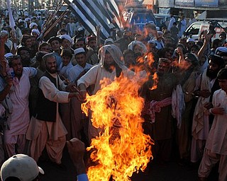 Angry supporters of Pakistani religious party Jamiat Ulema-e-Islam burn representation of the United States during a rally to condemn the killing of Osama bin Laden in Quetta, Pakistan on Monday, May 2, 2011. al-Qaida chief Osama bin Laden was slain in his hideout in Pakistan early Monday in a firefight with U.S. forces, ending a manhunt that spanned a decade.